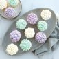 Cupcakes on a platter and plate, showcasing frosting designs using tips from set.