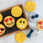 Decorated and plain baked emoji stamped cookies with cookie stamps