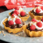 Cooked timbales filled with chocolate pudding, whipped cream, and raspberries