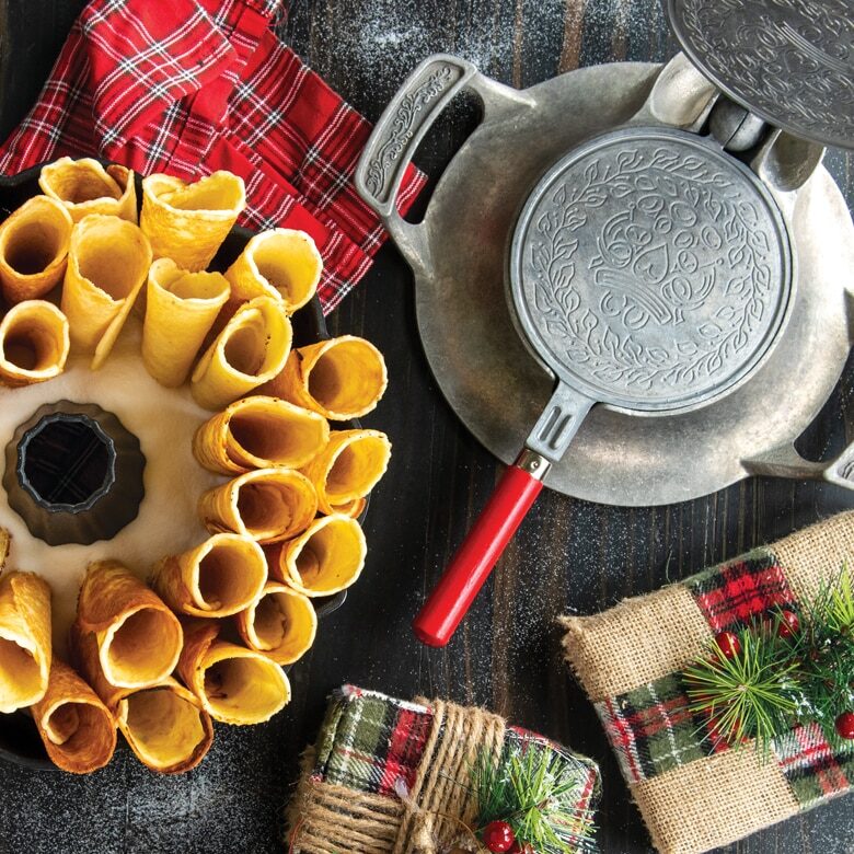  Image of cooked krumkake in a cone shape served inside a Bundt in a holiday scene