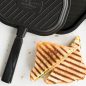 Grill press with grilled cheese sandwich wedges