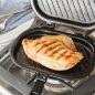 Open grill press with grilled chicken breast
