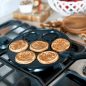 Pancake pan on stovetop with cooked Autumn pancakes