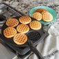 Cooked mini round waffles on pancake pan