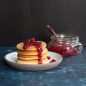 Lingonberry jam on top of stacked pancakes.