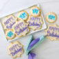 Decorated cookies on a platter, deco pen on surface used to write frosted words on cookies