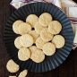 Baked embossed cookies on plate with holiday towel