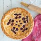 baked cherry pie with cherry design crust, rolling pin