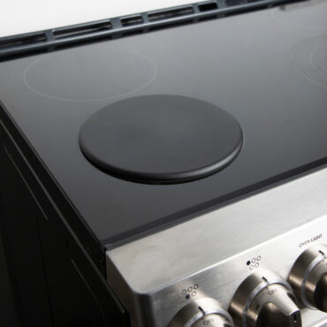 Lifestyle image of heat tamer over induction stovetop