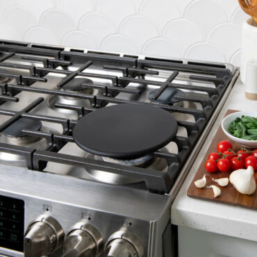 Lifestyle image of heat tamer over a gas stovetop