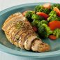 cooked chicken breast with broccoli and carrots on plate