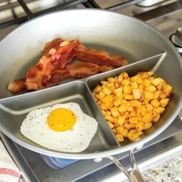 Breakfast food cooked in 3-in-1 divided saute pan on stovetop