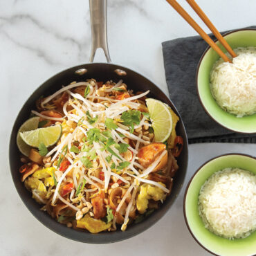 stir fry with cashews in Nordic Ware 8-inch spun aluminum wok with white rice in green bowls
