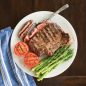 Grilled steak, tomatoes, asparagus on plate