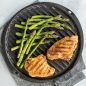 Grilled asparagus and chicken on grill side of griddle, with towel