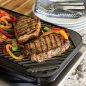 Grilled steak and pepper on grill side of griddle, on stovetop