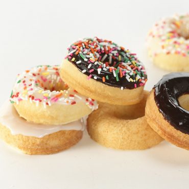 Baked decorated frosted donuts