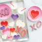 Decorated heart cookies and milk served on heart embossed pan