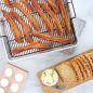 Baked bacon on Extra Large Oven Crisp Baking Tray, sliced bread on cutting board