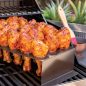 grilled chicken legs in stand on grill