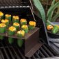 Grilled cheese stuffed jalapeno pepper in stand on grill