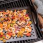 Grilled shrimp, vegetables on try on grill