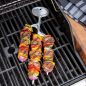 Skewer filled with beef and vegetable on grill