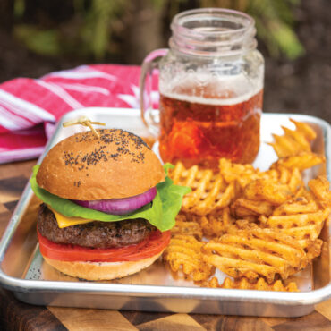 Nordic Ware aluminum quarter sheet baking pan with golden hamburger buns, natural silver finish