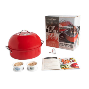 kettle smoker staged with smoker chips, thermometer open booklet, and box