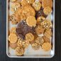 Variety of baked cookies piled on half sheet