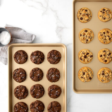Two nonstick half sheets with cookies