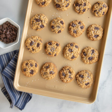 Golden chocolate chip cookies on Nordic Ware nonstick big sheet baking pan with light gold finish