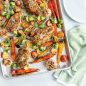 Baked sheet pan meal of chicken and vegetable on prism sheet