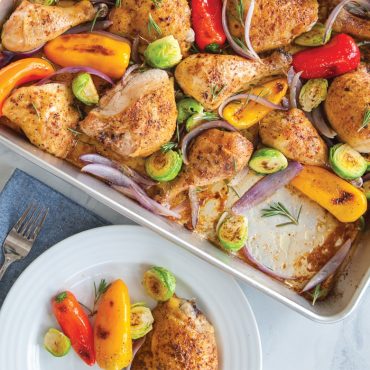 Baked chicken and vegetables in High Sided Sheet cake Pan close up