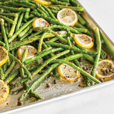 Nordic Ware aluminum jelly roll pan with roasted asparagus spears and lemon slices, natural finish