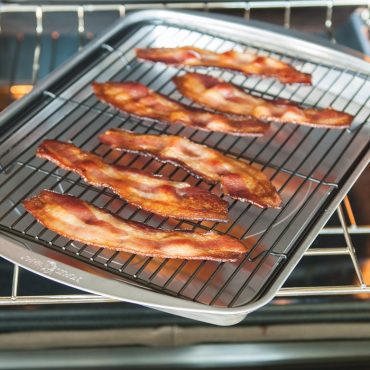 Baked bacon on bacon pan coming in oven