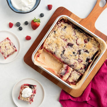 Nordic Ware aluminum square cake pan with fresh baked pie bars with whipped topping