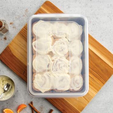 nordic ware 9x13 rectangular cake pan with lid filled with cinnamon rolls