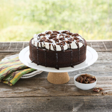 Double-layer chocolate cake with whipped cream and pecans, baked in Nordic Ware nonstick round cake pans
