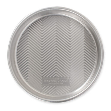Top view Prism 9â€ Round Cake Pan, showing embossed grid design on bottom							"