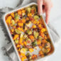 Roasted vegetables on Prism Eighth Sheet with hand holding pan and towel