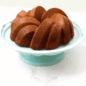 Bundt Cake Stand GIF hand putting on cover over baked cake
