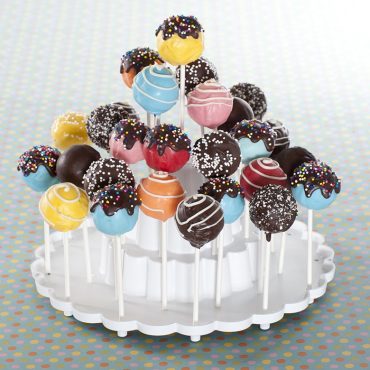 Variety of baked cake pops decorated and displayed on tiered stand