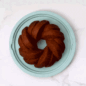 Hand putting cover on Bundt Keeper with cake inside GIF video