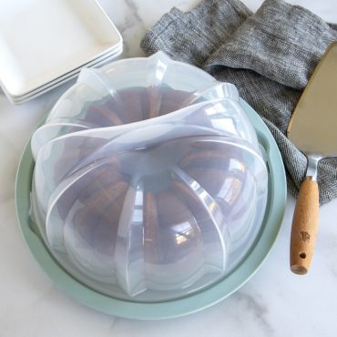 Translucent Bundt® Cake Keeper with cover over baked Bundt