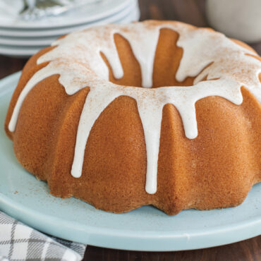 Bundt cake with glass on sea glass platter  baked in ProForm Anniversary Bundt Pan with Handles