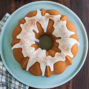 Golden glazed bundt cakewith icing, showcasing Nordic Ware Anniversary pan results