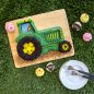 Baked and decorated tractor cake with animal cupcakes around (pigs, sheep, and chicks)