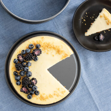 overhead of cheese cake placed on springform bottom with piece cut out and plated