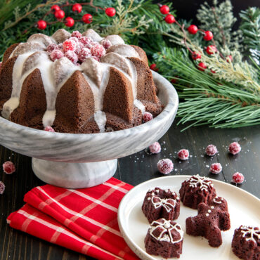 Holiday tea cakes on a plate along with a Vintage star Bundt cake in holiday scene